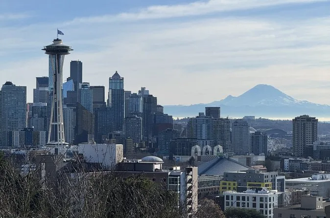 The Space Needle in front of the downtown skyline with Mount Rainier on the horizon